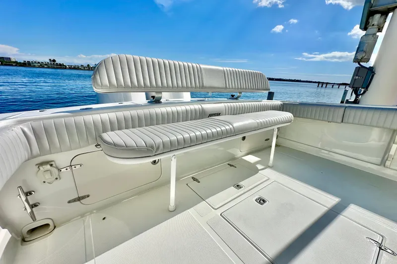  Yacht Photos Pics 2006 Jupiter 31FS boat interior with cushioned seating, overlooking calm blue waters.