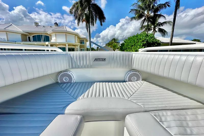  Yacht Photos Pics Luxurious interior of a 2006 Jupiter 31FS boat with plush seating and speakers.