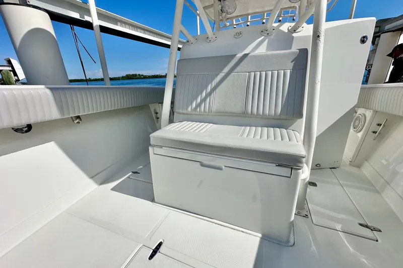  Yacht Photos Pics 2006 Jupiter 31FS boat interior with white seating and open deck, under clear blue sky.