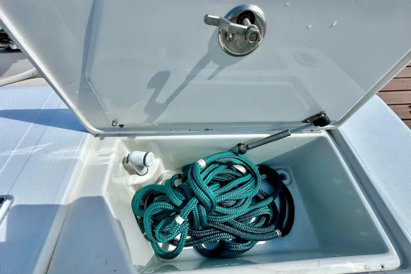  Yacht Photos Pics Open storage compartment on 2006 Jupiter 31FS boat with coiled rope inside.