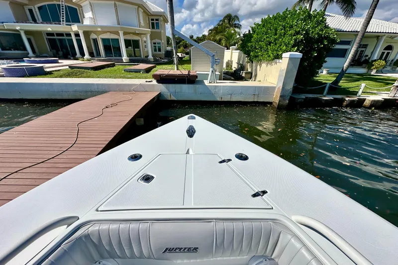  Yacht Photos Pics 2006 Jupiter 31FS boat docked near luxurious waterfront home.