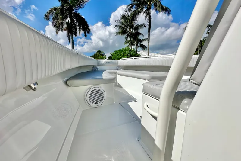  Yacht Photos Pics 2006 Jupiter 31FS boat interior with white seating, palm trees, and blue sky background.