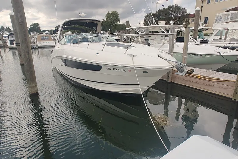  Yacht Photos Pics 2017 Sea Ray Sundancer 310 docked at a marina under cloudy skies.
