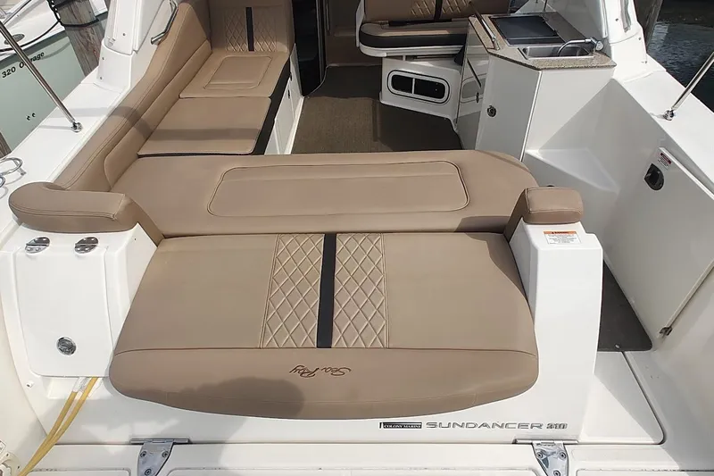  Yacht Photos Pics 2017 Sea Ray Sundancer 310 interior with beige seating and kitchenette.