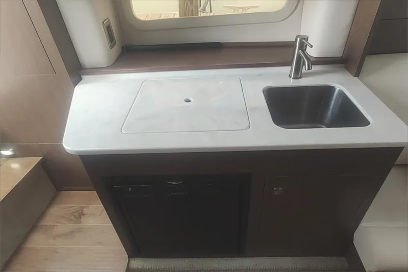  Yacht Photos Pics Compact kitchen area in 2017 Sea Ray Sundancer 310 with sink and countertop.