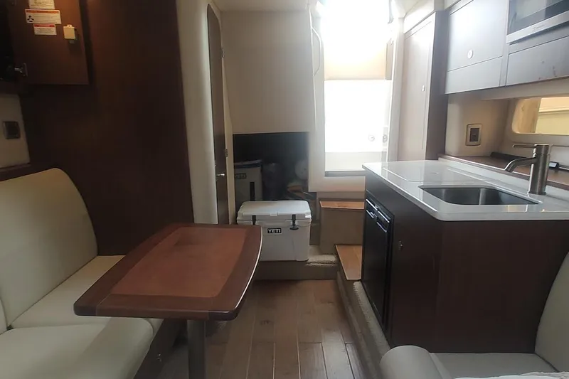  Yacht Photos Pics Interior of 2017 Sea Ray Sundancer 310 yacht with kitchenette and seating area.