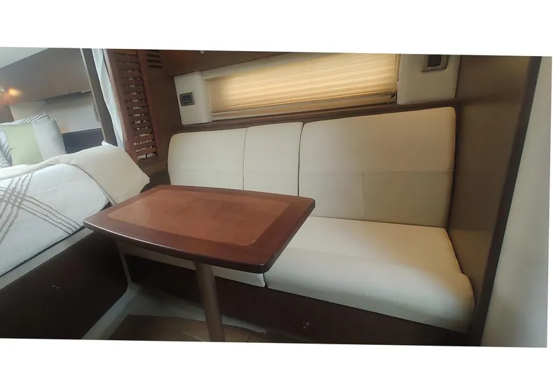  Yacht Photos Pics Interior of 2017 Sea Ray Sundancer 310 with cozy seating and wooden table.