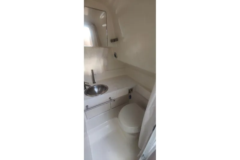 Yacht Photos Pics 2017 Sea Ray Sundancer 310 bathroom with sink and toilet, compact and modern design.