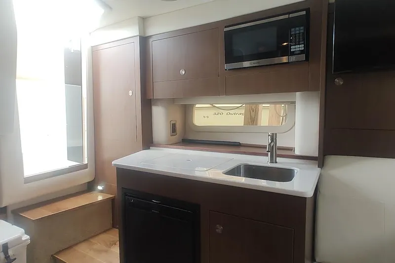  Yacht Photos Pics Interior of 2017 Sea Ray Sundancer 310 yacht with modern kitchenette and appliances.
