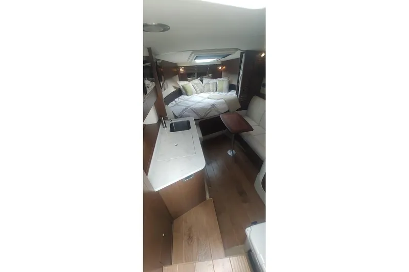  Yacht Photos Pics 2017 Sea Ray Sundancer 310 interior with cozy bed, kitchenette, and seating area.