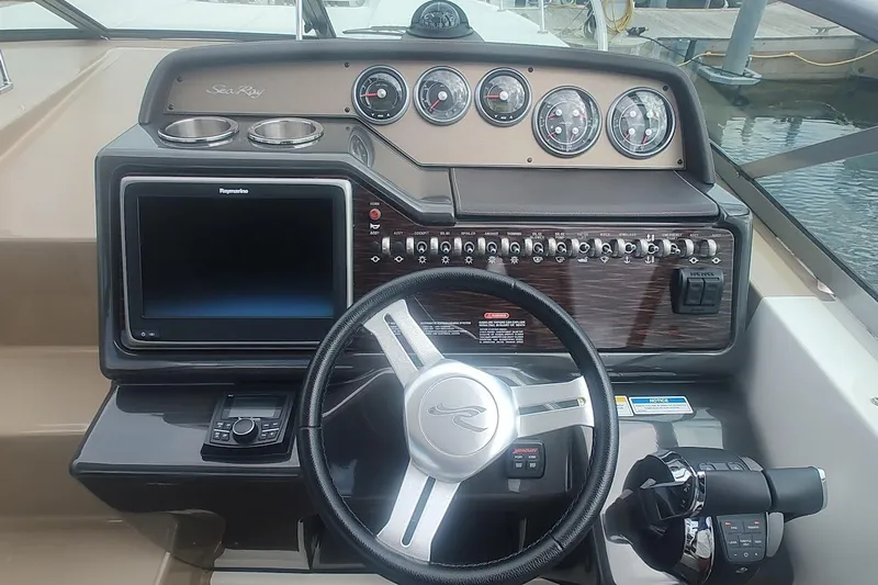  Yacht Photos Pics 2017 Sea Ray Sundancer 310 helm with steering wheel, gauges, and navigation display.