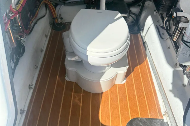 Salty Dog 2 Yacht Photos Pics Boat interior with a toilet on a wooden floor, Yellowfin 32, 2013 model.
