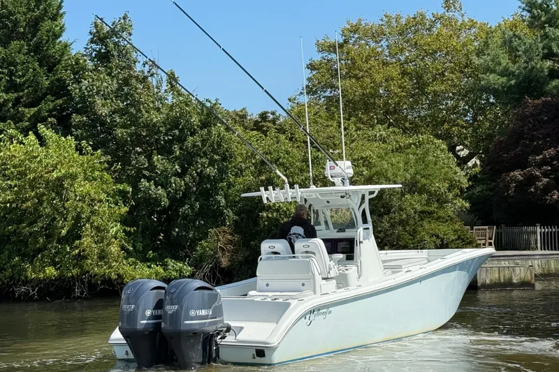 Salty Dog 2 Yacht Photos Pics 2013 Yellowfin 32 boat with dual Yamaha engines on a calm waterway.