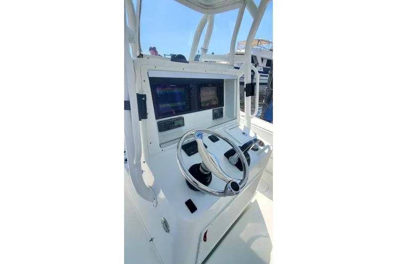 Salty Dog 2 Yacht Photos Pics 2013 Yellowfin 32 boat console with steering wheel and navigation screens.