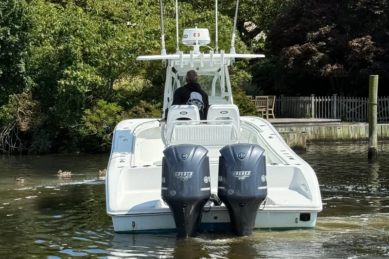 Salty Dog 2 Yacht Photos Pics 2013 Yellowfin 32 boat with dual Yamaha engines on a calm river.
