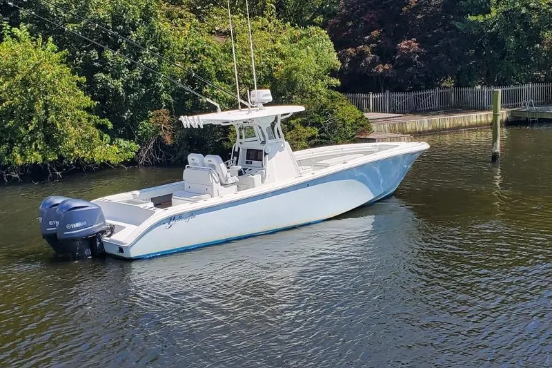 Salty Dog 2 Yacht Photos Pics 2013 Yellowfin 32 boat with dual Yamaha engines on a calm river.