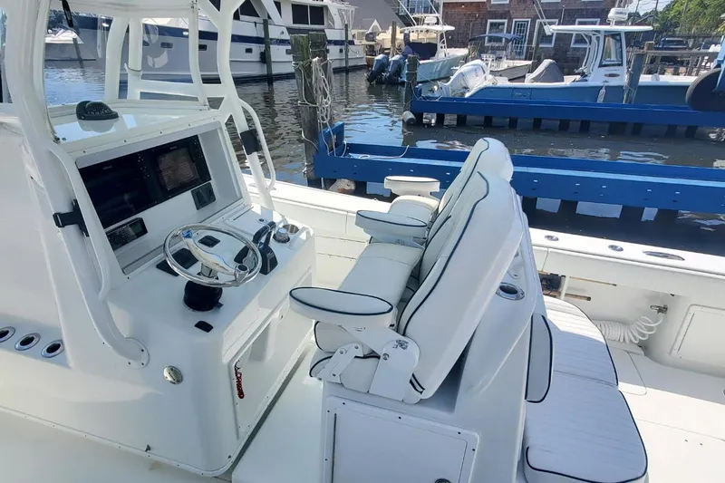 Salty Dog 2 Yacht Photos Pics 2013 Yellowfin 32 boat interior with steering console and seating at marina.