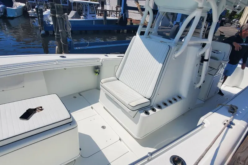 Salty Dog 2 Yacht Photos Pics 2013 Yellowfin 32 boat interior with white seating and fishing rod holders at a marina.