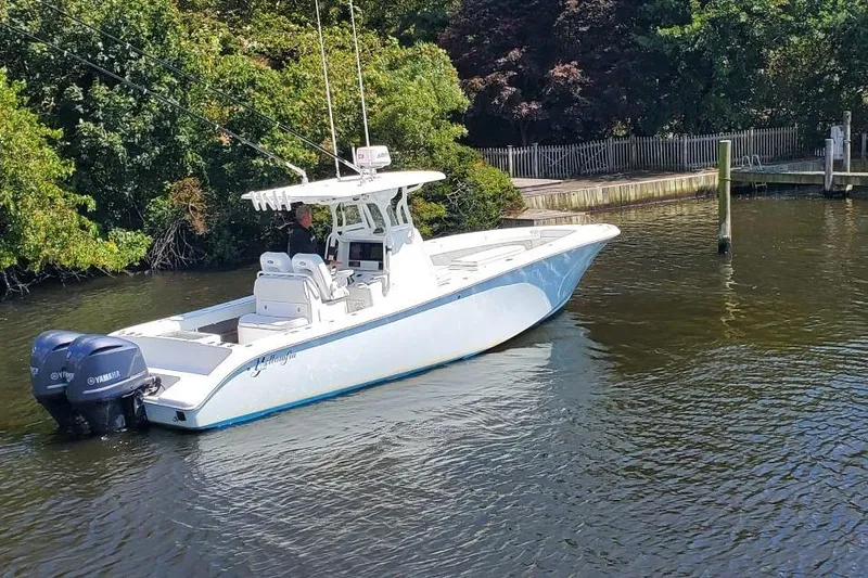 Salty Dog 2 Yacht Photos Pics 2013 Yellowfin 32 boat with dual Yamaha engines on a calm river.