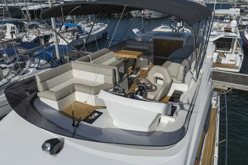 Neo Yacht Photos Pics 2022 Beneteau Monte Carlo 52 yacht with spacious upper deck and seating area.