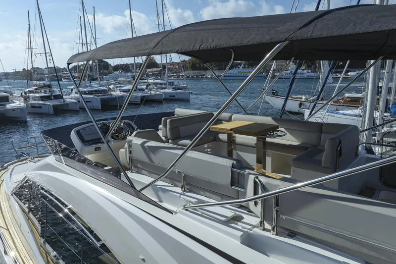 Neo Yacht Photos Pics Beneteau Monte Carlo 52 yacht, 2022 model, docked with spacious deck and seating area.