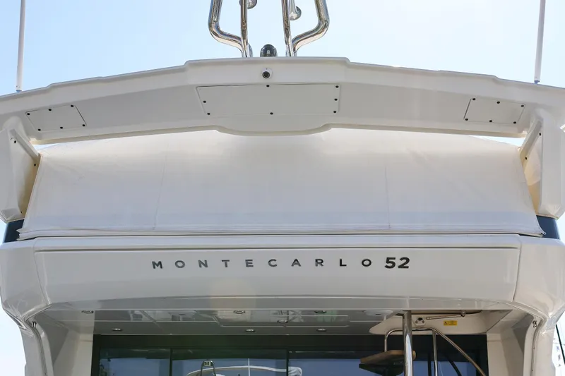 Neo Yacht Photos Pics 2022 Beneteau Monte Carlo 52 yacht, rear view showcasing sleek design and branding.