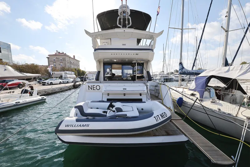 Neo Yacht Photos Pics 2022 Beneteau Monte Carlo 52 yacht docked at marina, rear view.