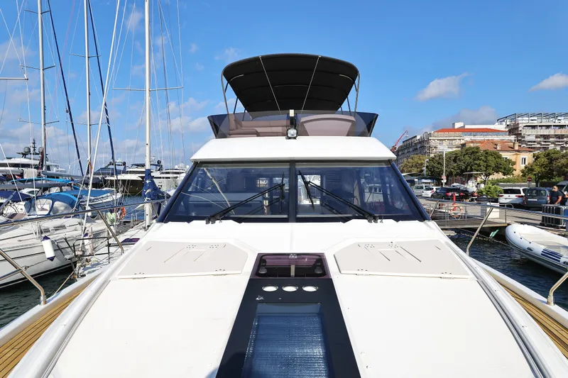 Neo Yacht Photos Pics Beneteau Monte Carlo 52 yacht, 2022 model, docked in a marina under a clear blue sky.