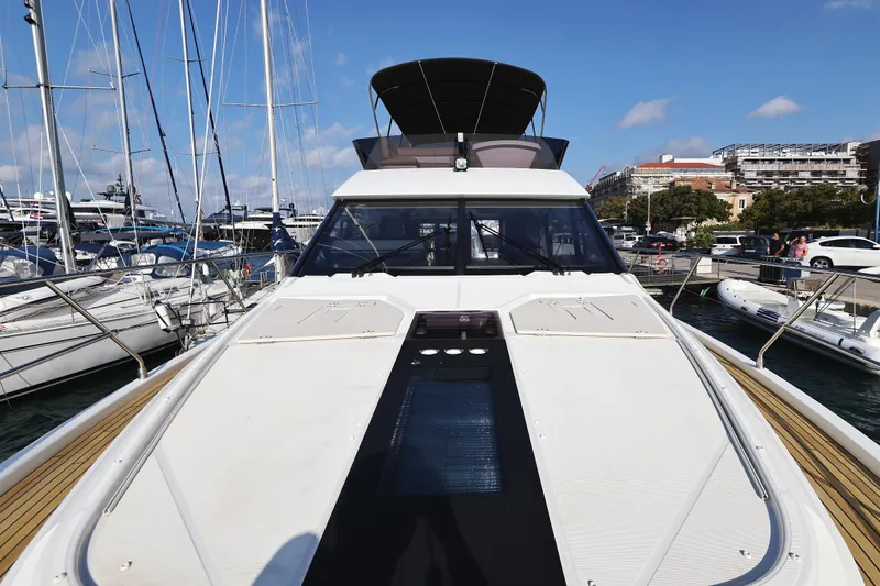 Neo Yacht Photos Pics 2022 Beneteau Monte Carlo 52 yacht docked at marina, showcasing sleek design and spacious deck.