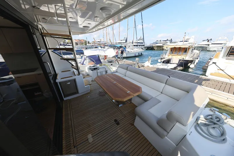 Neo Yacht Photos Pics Luxurious deck of 2022 Beneteau Monte Carlo 52 yacht with seating and table.