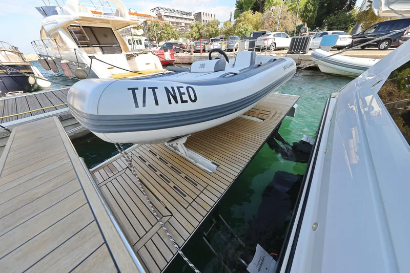 Neo Yacht Photos Pics Beneteau Monte Carlo 52, 2022 model, docked with tender boat T/T NEO on hydraulic platform.
