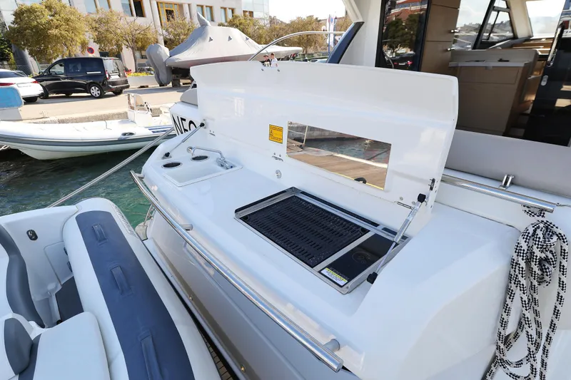 Neo Yacht Photos Pics Outdoor grill on 2022 Beneteau Monte Carlo 52 yacht, docked at marina.