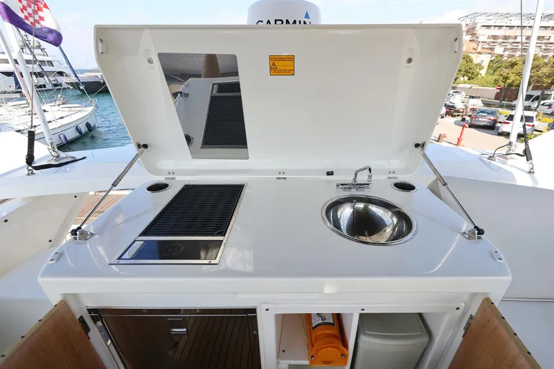Neo Yacht Photos Pics Outdoor kitchen on 2022 Beneteau Monte Carlo 52 yacht with sink and grill.