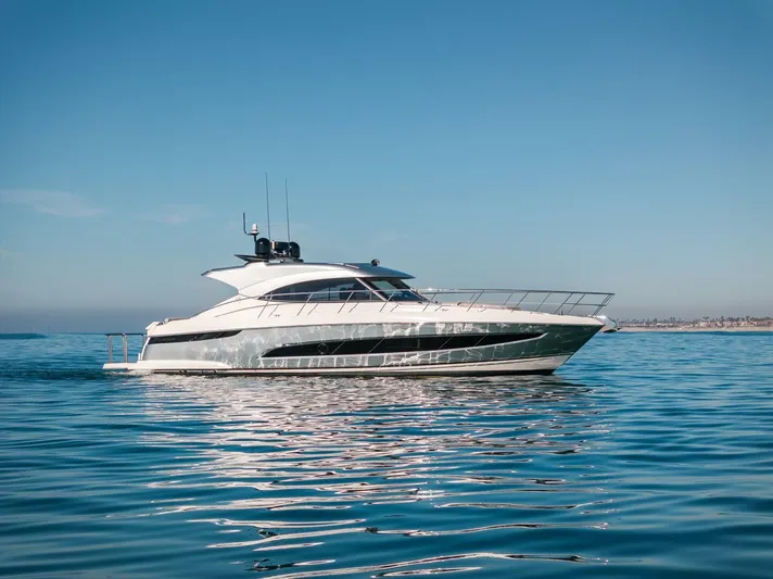 Ventures64 Yacht Photos Pics 2022 Riviera 4800 Sport Yacht cruising on calm blue waters.