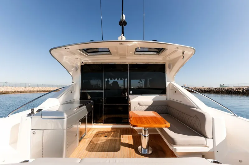 Ventures64 Yacht Photos Pics 2022 Riviera 4800 Sport Yacht with sleek deck and luxurious seating area.