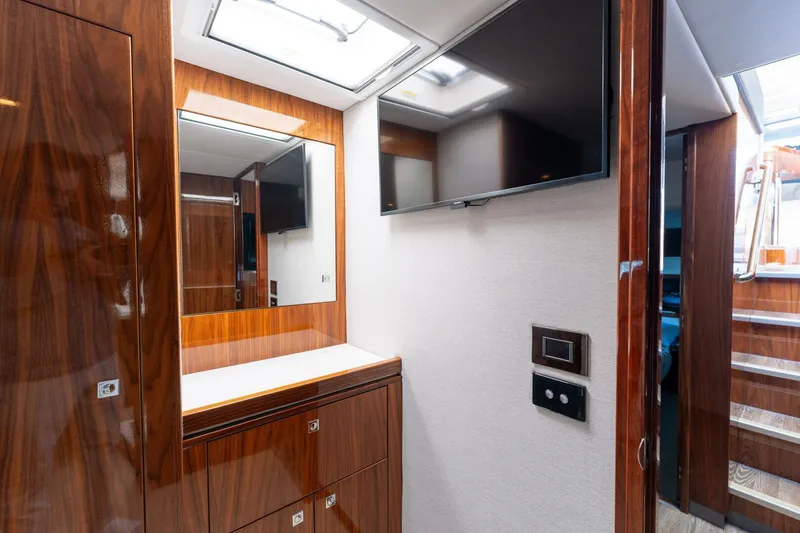 Ventures64 Yacht Photos Pics Luxurious interior of 2022 Riviera 4800 Sport Yacht with wood finish and modern amenities.