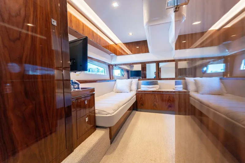 Ventures64 Yacht Photos Pics Luxurious interior of 2022 Riviera 4800 Sport Yacht with plush seating and elegant wood finishes.
