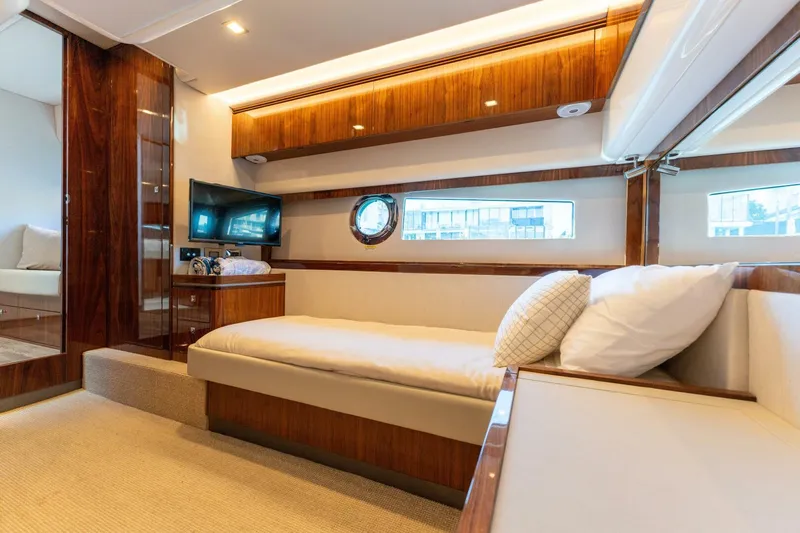 Ventures64 Yacht Photos Pics Luxurious interior of 2022 Riviera 4800 Sport Yacht with elegant wood finishes and cozy seating.