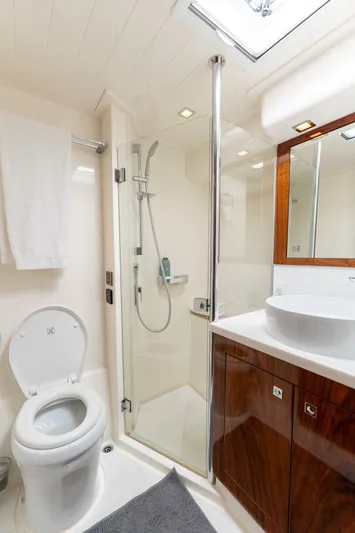 Ventures64 Yacht Photos Pics Luxurious bathroom in 2022 Riviera 4800 Sport Yacht with modern fixtures and elegant design.