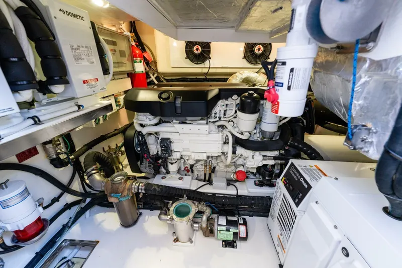 Ventures64 Yacht Photos Pics Engine room of 2022 Riviera 4800 Sport Yacht with visible machinery and equipment.