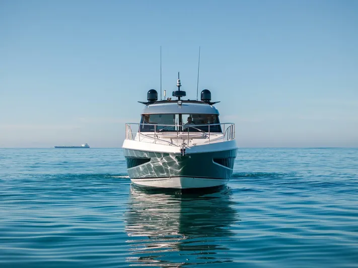 Ventures64 Yacht Photos Pics 2022 Riviera 4800 Sport Yacht cruising on calm blue waters.