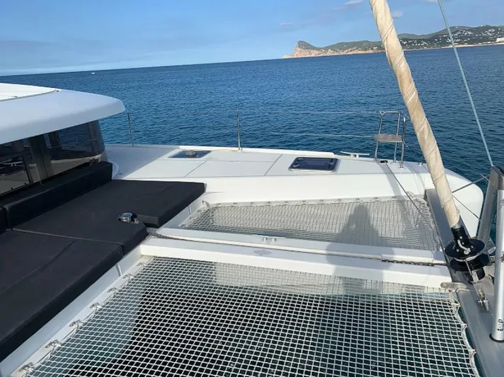  Yacht Photos Pics 2024 Lagoon 42 catamaran deck with ocean view and distant coastline.