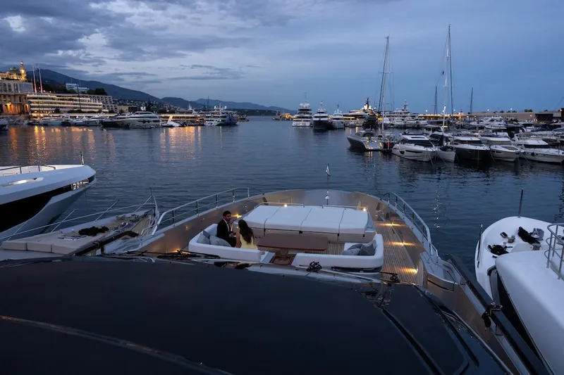 Tasty Waves Yacht Photos Pics Luxury yacht Riva 130' Bellissima 2025 docked in scenic marina at dusk.
