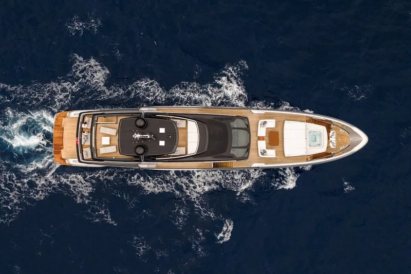 Tasty Waves Yacht Photos Pics Aerial view of 2025 Riva 130' Bellissima yacht cruising on open sea.