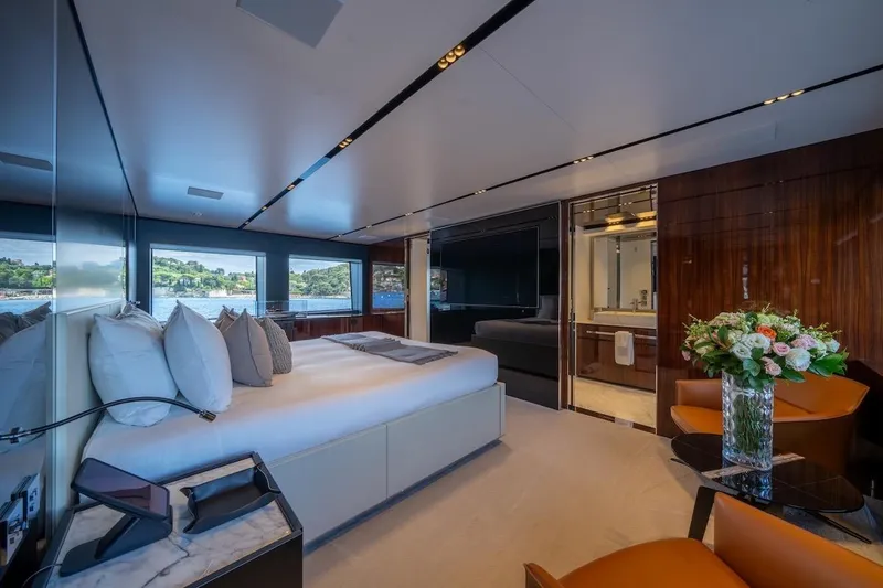 Tasty Waves Yacht Photos Pics Luxurious bedroom interior of 2025 Riva 130' Bellissima yacht with elegant decor and scenic views.