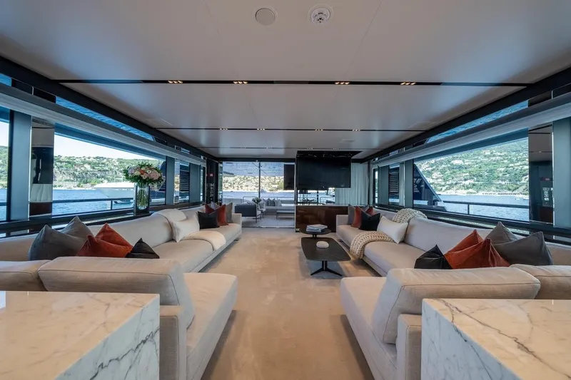 Tasty Waves Yacht Photos Pics Luxurious interior of 2025 Riva 130' Bellissima yacht with elegant seating and panoramic views.