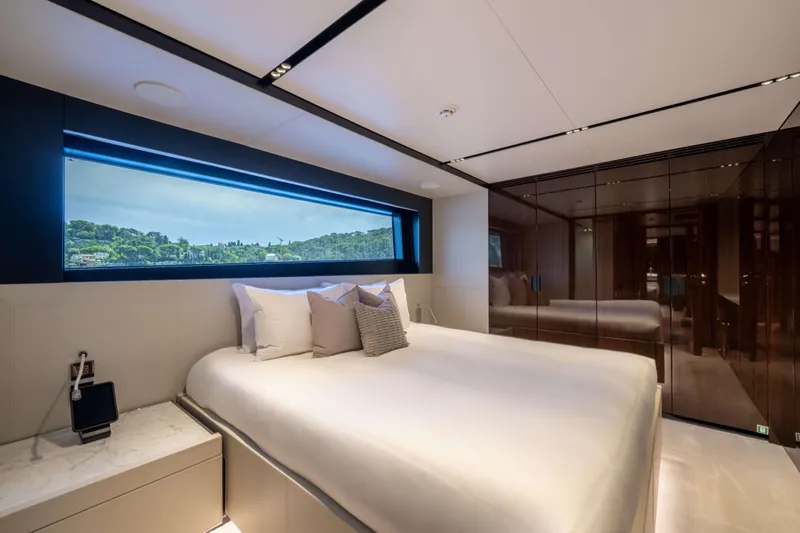Tasty Waves Yacht Photos Pics Luxurious bedroom interior of 2025 Riva 130' Bellissima yacht with scenic window view.