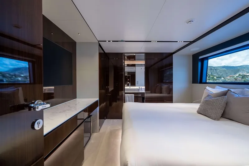 Tasty Waves Yacht Photos Pics Luxurious bedroom interior of 2025 Riva 130' Bellissima yacht with scenic window view.