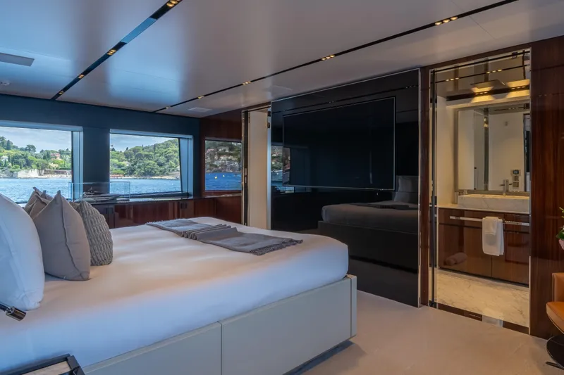 Tasty Waves Yacht Photos Pics Luxurious bedroom interior of 2025 Riva 130' Bellissima yacht with scenic ocean view.