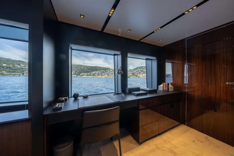 Tasty Waves Yacht Photos Pics Luxurious interior of 2025 Riva 130' Bellissima yacht with ocean view through windows.